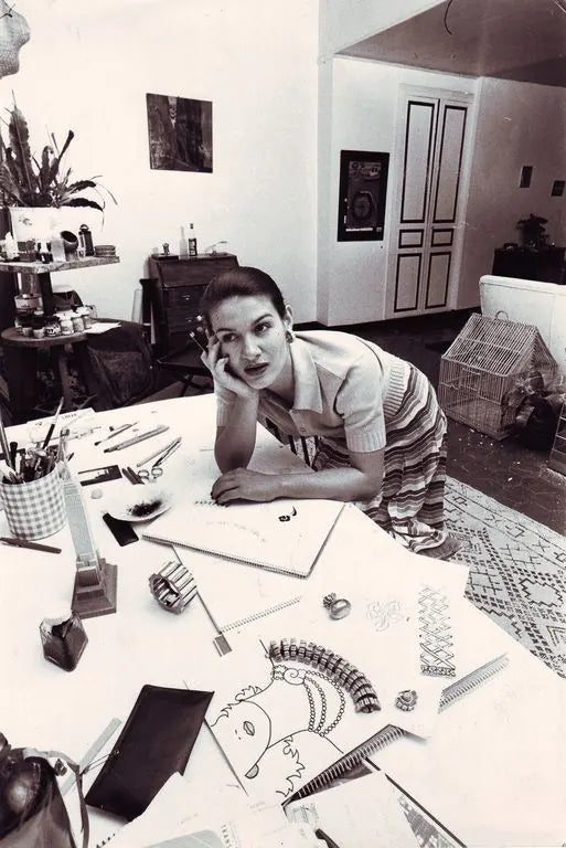 The designer at her drawing table in the studio